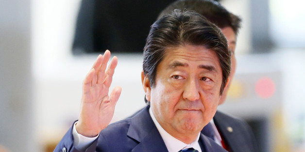 Japanese Prime Minister Shinzo Abe waves as he arrives at the National Convention Center for scheduled bilateral meeting with Philippine President Rodrigo Duterte on the sidelines of the 28th and 29th ASEAN Summits and other related summits Tuesday, Sept. 6, 2016 in Vientiane, Laos. (AP Photo/Bullit Marquez)