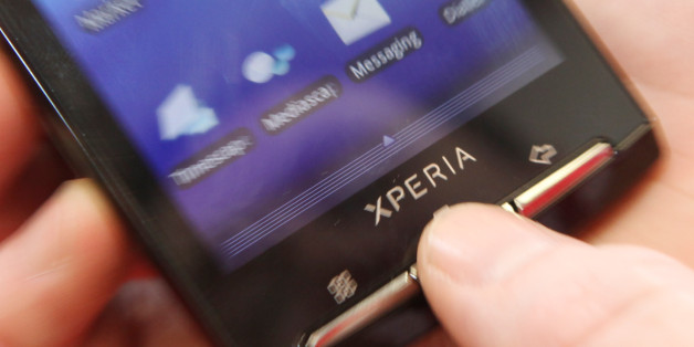 A user pushes the menu button on a Sony Ericsson Xperia X10 smartphone running Google Inc.'s Android operating system in London, U.K., on Wednesday, July 7, 2010. Global smartphone sales will rise 36 percent to 247 million in 2010, ISuppli Corp. said in April. Photographer: Chris Ratcliffe/Bloomberg via Getty Images