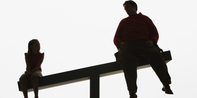 Large man and small girl on unbalanced plank
