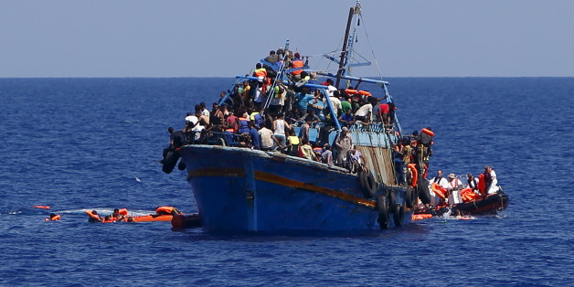 Migrants hang onto flotation tubes in the sea after jumping from an overloaded wooden boat during a rescue operation 10.5 miles (16 kilometres) off the coast of Libya August 6, 2015. An estimated 600 migrants on the boat were rescued by the international non-governmental organisations Medecins san Frontiere (MSF) and the Migrant Offshore Aid Station (MOAS) without loss of life on Thursday afternoon, a day after more than 200 migrants are feared to have drowned in the latest Mediterranean boat t