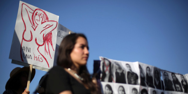 Activists take part in a march to protest violence against women and the murder of a 16-year-old girl in a coastal town of Argentina last week, at Revolucion monument, in Mexico City, Mexico, October 19, 2016. The sign reads, "Not one more". REUTERS/Edgard Garrido