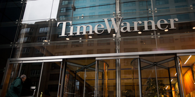 A pedestrian looks inside the Time Warner Inc. Center in New York, U.S., on Saturday, Oct. 22, 2016. According to a statement Saturday, AT&T agreed to buy Time Warner for $107.50 a share. Photographer: Michael Nagle/Bloomberg via Getty Images