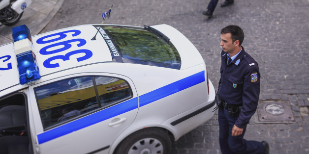 Elevated view of Greek policeman and car