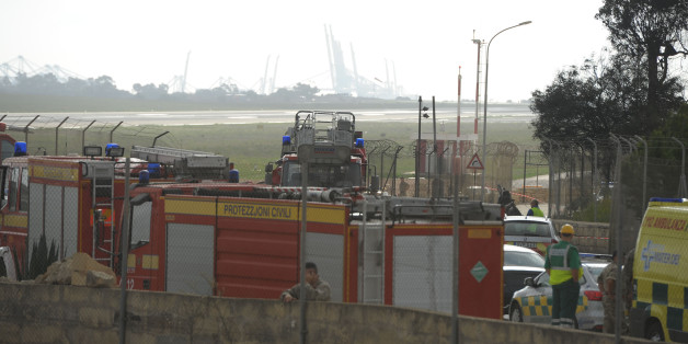Emergency workers are seen at the site of the wreckage of a small twin engined plane which crashed shortly after takeover from Malta International Airport, on October 24, 2016. / AFP / Matthew Mirabelli / Malta OUT (Photo credit should read MATTHEW MIRABELLI/AFP/Getty Images)