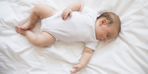 Baby girl (2-5 months) sleeping in bed