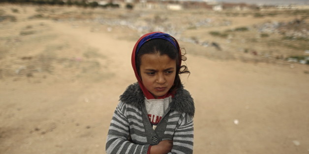 Shahda, 8, stands at the impoverished Zhor neighborhood of Kasserine, where young people have been demonstrating for jobs since last week, January 28, 2016. REUTERS/Zohra Bensemra