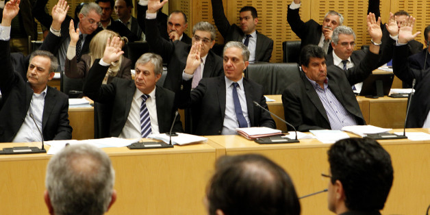 Cyprus lawmakers vote on key bills aimed at securing a broader bailout package from international creditors in parliament in capital Nicosia, Cyprus, late Friday, March 22, 2013. Cyprus lawmakers have approved three key bills aiming to raise enough money to qualify the country for a broader bailout package and help it avoid financial ruin. (AP Photo/Petros Karadjias)