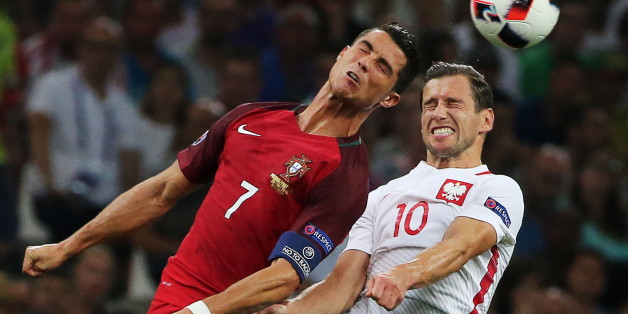 MARSEILLE, FRANCE - JUNE 30, 2016: Portugal's Cristiano Ronaldo (7) and Grzegorz Krychowiak (10) jump to head the ball in their 2016 UEFA European Football Championship quaterfinal match at Stade Velodrome. Alexander Demianchuk/TASS (Photo by Alexander Demianchuk\TASS via Getty Images)
