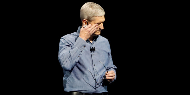 Apple Inc. CEO Tim Cook wipes his eyes after leading a moment of silence for the victims of the attack in Orlando as he opens the company's World Wide Developers Conference in San Francisco, California June 13, 2016. REUTERS/Stephen Lam