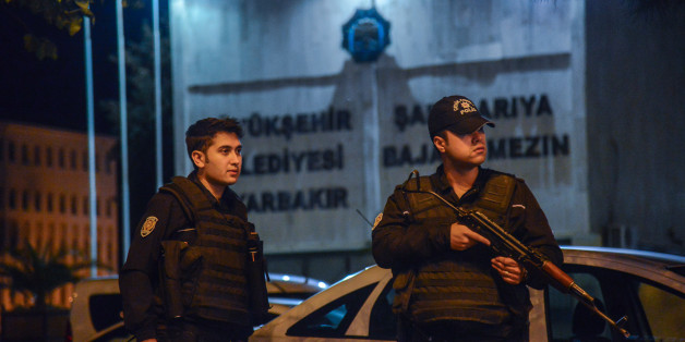 Armed Turkish anti riot police officers stand in front of the Diyarbakir's municipality headquarters on October 25, 2016 in Diyarbakir.
The two co-mayors of Diyarbakir, the biggest Kurdish-majority city in southeast Turkey, have been arrested as part of a 'terrorism' enquiry, security officials said. There was a heavy police presence around the town hall following the arrests of Gultan Kisanak and Firat Anli, who together lead a city that has been rocked by clashes between security forces and members of the outlawed Kurdistan Workers' Party (PKK).
/ AFP / ILYAS AKENGIN (Photo credit should read ILYAS AKENGIN/AFP/Getty Images)