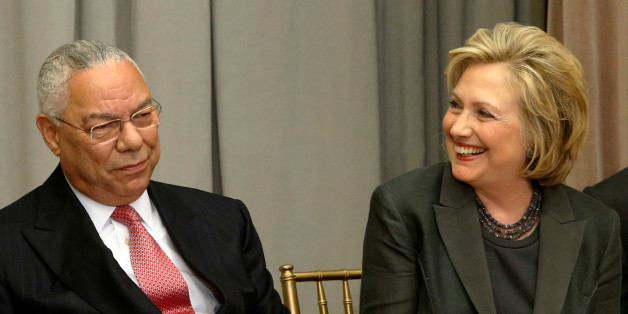 Former U.S. Secretaries of State Colin Powell (L) and Hillary Clinton listen to remarks at a groundbreaking ceremony for the U.S. Diplomacy Center in Washington September 3, 2014. REUTERS/Jonathan Ernst/File Photo