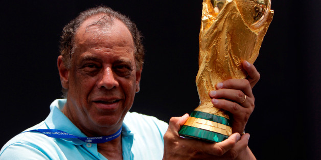 Former Brazilian soccer captain Carlos Alberto Torres holds the 2014 FIFA World Cup Brazil trophy during its unveiling ceremony at a Soccerex event at Copacabana beach in Rio de Janeiro, November 21, 2010. REUTERS/Bruno Domingos/File Photo