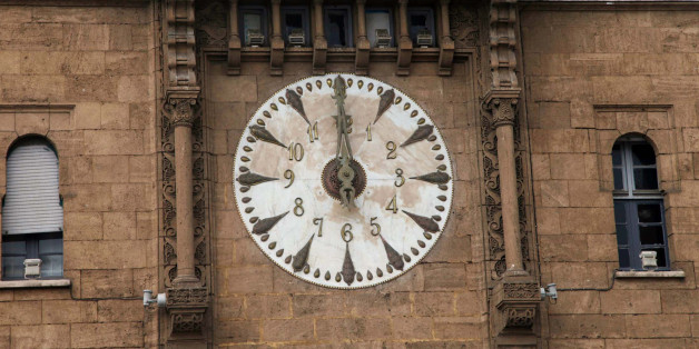 A clock above the entrance to Rabat's post office strikes noon March 30, 2012. REUTERS/Youssef Boudlal (MOROCCO - Tags: SOCIETY BUSINESS)