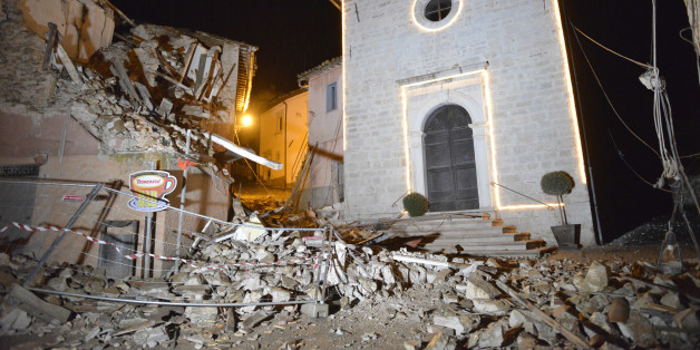 The Church of San Sebastiano stands amidst damaged houses in Castelsantangelo sul Nera, Italy, Wednesday, Oct 26, 2016 following an earthquake,. A pair of strong aftershocks shook central Italy late Wednesday, crumbling churches and buildings, knocking out power and sending panicked residents into the rain-drenched streets just two months after a powerful earthquake killed nearly 300 people. (AP Photo/Sandro Perozzi)