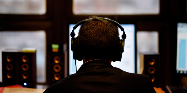 A man uses headphones while working at the Justice Ministry's Agency for comunications capturing in Buenos Aires, Argentina, July 14, 2016. Picture taken July 14, 2016. REUTERS/Marcos Brindicci