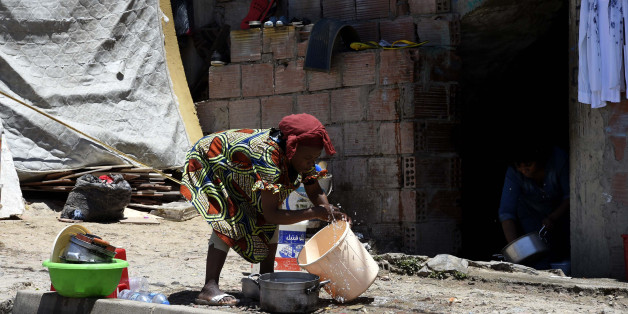 A Sub-Saharan woman does some washing-up at the bottom of a makeshift building where she lives with other fellow migrants in impoverished conditions, on May 29, 2016, in the capital Algiers. In the past, Algeria was a land of emigration, millions of its citizens exiled to France, but in recent years it has become a destination country for many West Africans. Nigerians, Malians, Cameroonians, brave the horrors of the Sahara to find refuge in the largest country in Africa, as the crossing to Euro