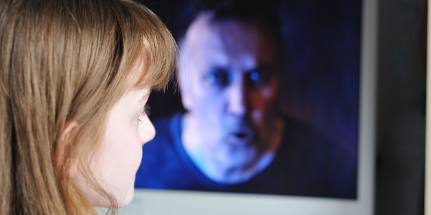 Child looking at horrible man on screen. Useful to show dangers of Internet or unsupervised viewing