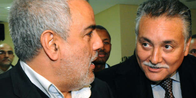 New Moroccan Prime minister Abdelillah Benkirane (L) greets Nabil Benabdellah (R), secretary general of the Socialism and Progress Party at Justice and Development Party (PJD) headquarters in Rabat on December 12, 2011. Abdelilah Benkirane, who was appointed prime minister by King Mohammed VI after his Justice and Development Party (PJD) secured the most votes in last month's election, has been in talks with other parties to form a coalition. AFP PHOTO /ABDELHAK SENNA (Photo credit should read A