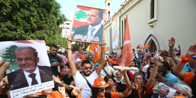 People carry pictures of newly appointed Lebanese President Michel Aoun while waving Free Patriotic Movement (FPM) flags in the Haret Hreik area, southern suburbs of Beirut, Lebanon October 31, 2016. REUTERS/Khalil Hassan