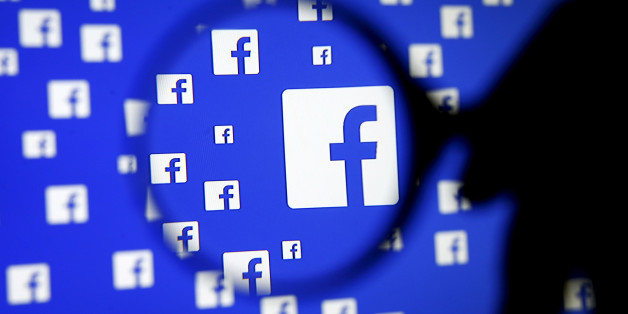 A man poses with a magnifier in front of a Facebook logo on display in this illustration taken in Sarajevo, Bosnia and Herzegovina, December 16, 2015. REUTERS/Dado Ruvic/Illustration/File Photo GLOBAL BUSINESS WEEK AHEAD PACKAGE - SEARCH "BUSINESS WEEK AHEAD JULY 25" FOR ALL IMAGES