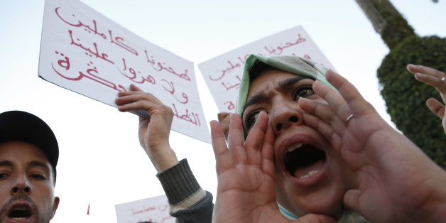 A Moroccan shouts as thousands of Moroccans protest against the death of Mouhcine Fikri last Friday, with placard reading "mash us of respect us", in the northern city of Hoceima in Rabat, Morocco, Sunday, Oct. 30, 2016. Crowds of Moroccans are protesting, seemingly incensed by the death of a fisherman crushed to death in a garbage truck. (AP Photo/Abdeljalil Bounhar)