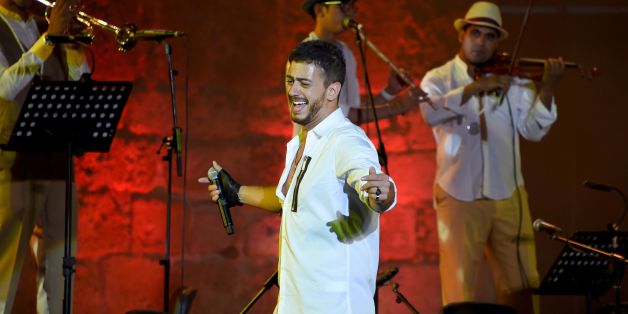 Morocco singer Saad Lamjarred performs with Ukrainian Orchestra Symphonic at the opening of the Carthage Festival on July 30, 2016 at the romain theatre of carthage near Tunis. / AFP / FETHI BELAID (Photo credit should read FETHI BELAID/AFP/Getty Images)