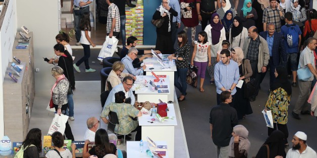 People look at books on November 1, 2016 during the 21em International Book Fair of Algiers (SILA) and Exhibition Centre in Algiers, Algeria. (Photo by Billal Bensalem/NurPhoto via Getty Images)