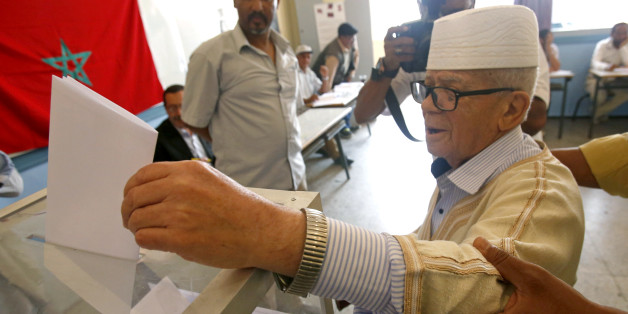 A man casts her ballot at a polling station for the parliamentary elections, in Rabat, Morocco, Friday, Oct. 7, 2016. Millions of Moroccans hit the voting booths, with worries about joblessness and extremism on many minds as they choose which party will lead their next government.(AP Photo/Abdeljalil Bounhar)