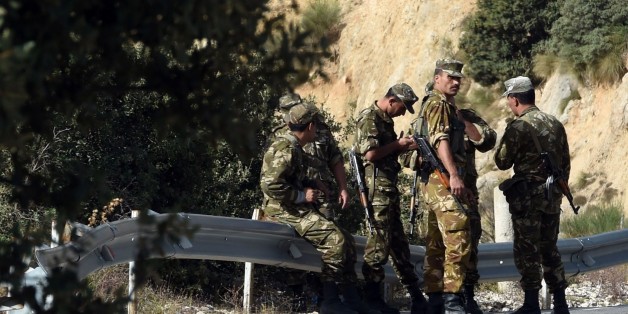 Algerian troops rest as they conduct a search operation on October 10, 2014, near the village of Ait Ouabane, 80 kilometres south of Tizi Ouza, for the body of 55-year old French tourist and moutain-guide Herve Gourdel, who was kidnapped on September 21 while hiking in Algeria's Djurdjura National Park, and beheaded three days later by a group linked to Islamic State jihadists in Iraq and Syria. Algeria is continuing to devote significant resources in Kabylia to find the body of Gourdel Herve an