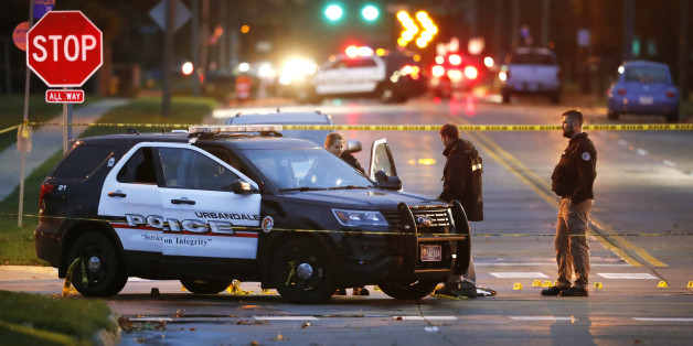 Law enforcement officials investigate at the scene of a shooting, Wednesday, Nov. 2, 2016, in Urbandale, Iowa. Authorities apprehended a man Wednesday suspected in the early morning killings of two Des Moines area police officers who were shot to death while sitting in their patrol cars in what authorities described as separate ambush-style attacks. (AP Photo/Charlie Neibergall)