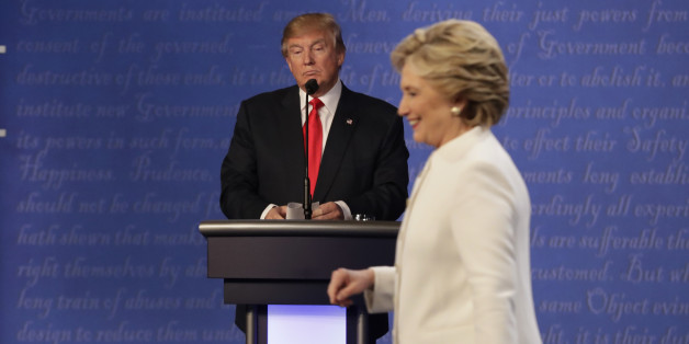 Republican presidential nominee Donald Trump waits behind his podium as Democratic presidential nominee Hillary Clinton makes her way off the stage following the third presidential debate at UNLV in Las Vegas, Wednesday, Oct. 19, 2016. (AP Photo/David Goldman)