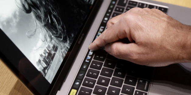 A guest looks at a the Touch Bar on MacBook computer shown in a demo room following the announcement of new products at Apple headquarters Thursday, Oct. 27, 2016, in Cupertino, Calif. (AP Photo/Marcio Jose Sanchez)