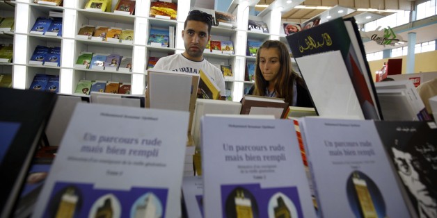 People look at books on November 1, 2016 during the 21em International Book Fair of Algiers (SILA) and Exhibition Centre in Algiers, Algeria. (Photo by Billal Bensalem/NurPhoto via Getty Images)