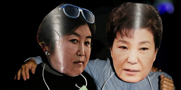 Protesters wearing cut-out of South Korean President Park Geun-hye (R) and Choi Soon-sil attend a protest denouncing President Park Geun-hye over a recent influence-peddling scandal in central Seoul, South Korea, October 27, 2016. REUTERS/Kim Hong-Ji