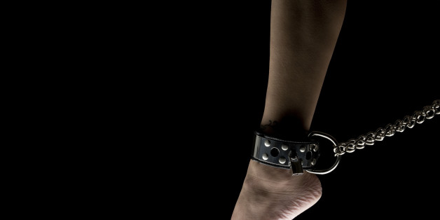Leg of woman tied to chain