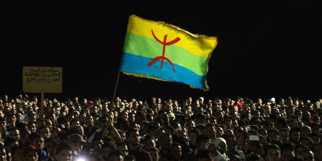 Protesters hold the Amazigh (Berber) flag as they shout slogans in the northern city of Al Hoceima on October 30, 2016, following the death of fishmonger Mouhcine Fikri, who was crushed to death on October 28 in a rubbish truck in Al Hoceima, as he reportedly tried to protest against a municipal worker seizing and destroying his wares.
Thousands of Moroccans on October 30 attended the funeral of the fishmonger whose gruesome death in a rubbish truck crusher has caused outrage across the North African country. An image of his inert body -- head and arm sticking out from under the lorry's crushing mechanism -- went viral on social media, sparking calls for protests nationwide including in the capital Rabat. / AFP / FADEL SENNA (Photo credit should read FADEL SENNA/AFP/Getty Images)