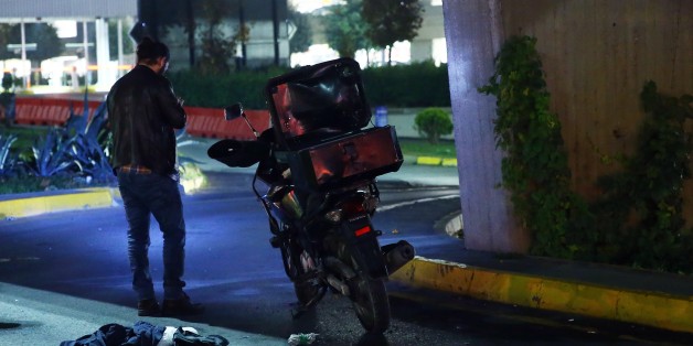 ISTANBUL, TURKEY - NOVEMBER 6 : Turkish police officers inspect a motorcycle that was used by 2 suspects who refused an order to stop at Ataturk International Airport in Istanbul, Turkey on early Sunday November 6, 2016. Turkish security forces detained both of the suspects at the airport which was on a brief lockdown. (Photo by Abdullah Coskun/Anadolu Agency/Getty Images)
