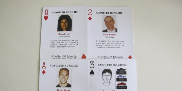 FILE - In this Oct. 24, 2013 file photo, details of a quadruple homicide are included on these playing cards passed out to inmates in South Carolina prisons, in Spartanburg, S.C. The cards were created by Tom Lucas, whose son, Brian, was killed in the unsolved shootings of four people inside a motorcycle shop in Spartanburg County on Nov. 6, 2003. Officials say the man arrested after authorities found a woman chained on his property in rural South Carolina killed four people and 3 other bodies were found on his property. Sheriff Chuck Wright said Saturday, Nov. 5, 2016, that his confession solved a 13-year-old case. Todd Christopher Kohlhepp confessed he was the shooter who killed four people at the motorcycle shop in Spartanburg County in 2003, Wright said. (AP Photo/Jeffrey Collins, File)