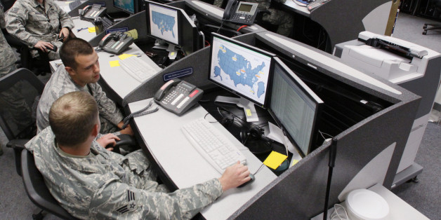 Personnel work at the Air Force Space Command Network Operations & Security Center at Peterson Air Force Base in Colorado Springs, Colorado July 20, 2010. U.S. national security planners are proposing that the 21st century's critical infrastructure -- power grids, communications, water utilities, financial networks -- be similarly shielded from cyber marauders and other foes. The ramparts would be virtual, their perimeters policed by the Pentagon and backed by digital weapons capable of circling the globe in milliseconds to knock out targets. To match Special Report USA-CYBERWAR/ REUTERS/Rick Wilking (UNITED STATES - Tags: MILITARY SCI TECH POLITICS)