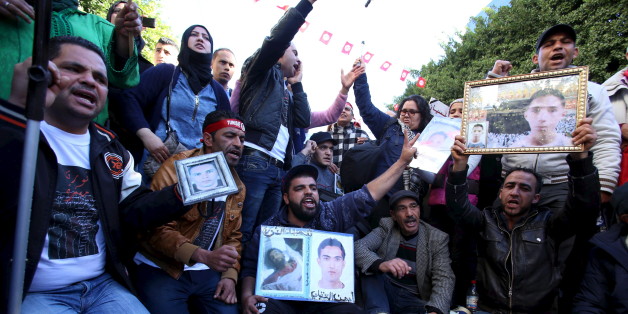 Moslem (C), a 27-year-old who was wounded while protesting during Tunisia's 2011 revolution, shouts slogans during a protest to commemorate the fifth anniversary of the revolution, in Habib Bourguiba Avenue in Tunis, Tunisia January 14, 2016. According to Moslem, he was demanding the appropriate treatment for the injuries he and other protesters received, as well as for the trial of the police officers who fired on them during the demonstrations. REUTERS/Zoubeir Souissi