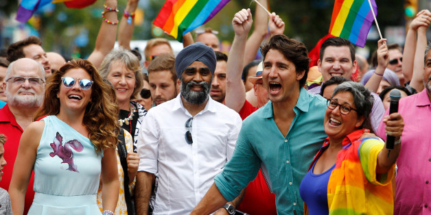 Canada's Prime Minister Justin Trudeau reacts as he and his wife Sophie Grégoire Trudeau (L) walk in the Vancouver Pride Parade in Vancouver, British Columbia, July 31, 2016. REUTERS/Ben Nelms