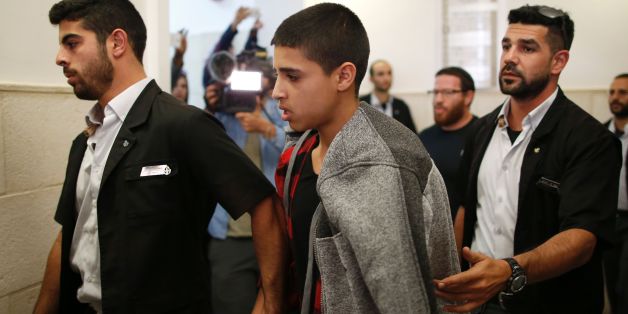 Ahmed Manasra (C), a 14-year old Palestinian boy, convicted of the attempted murder of two Israelis in a stabbing in October 2015, leaves the District Court in Jerusalem after his sentencing hearing on November 7, 2016.The court sentenced Manasra to 12 years in jail for the knife attack, his lawyer said. / AFP / AHMAD GHARABLI (Photo credit should read AHMAD GHARABLI/AFP/Getty Images)