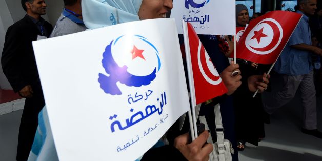 Supporters of Tunisia's Islamist Ennahdha Party wave the national and party flags on May 20, 2016 during the opening of Ennahdha's three-day congress in Tunis.Thousands of people attended the opening ceremony of the congress -- the first since 2012 -- held at a sports complex in Rades, south of the capital Tunis, amid heavy police security. / AFP / FETHI BELAID (Photo credit should read FETHI BELAID/AFP/Getty Images)