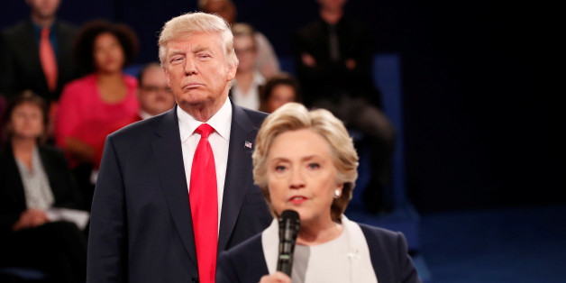 Republican U.S. presidential nominee Donald Trump listens as Democratic nominee Hillary Clinton answers a question from the audience during their presidential town hall debate at Washington University in St. Louis, Missouri, U.S., October 9, 2016. REUTERS/Rick Wilking /File Photo FROM THE FILES PACKAGE "THE CANDIDATES" - SEARCH CANDIDATES FILES FOR ALL 90 IMAGES