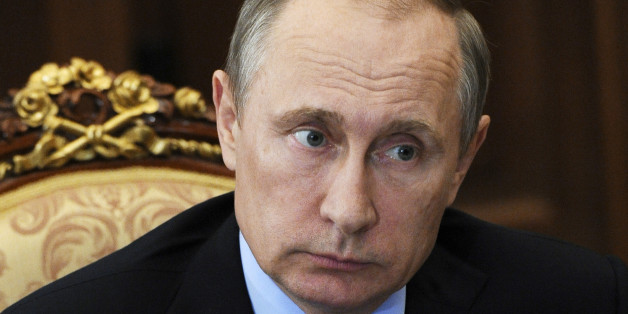 FILE - In this Tuesday, July 26, 2016 file photo, Russian President Vladimir Putin listens during a meeting in the Kremlin, in Moscow, Russia. Russian state-owned media does little to hide its preferences in the U.S. presidential election. News reports about the race for the White House on Russian television devote most of their time to elaborating on Donald Trumpâs allegations that Hillary Clinton is corrupt and the election is rigged. (Mikhail Klimentyev, Sputnik, Kremlin Pool Photo via