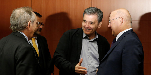 Italy's Finance Minister Pier Carlo Padoan, Greece's Finance Minister Euclid Tsakalotos and France's Finance Minister Michel Sapin attend a Eurozone finance ministers meeting in Brussels, Belgium, November 7, 2016. REUTERS/Yves Herman