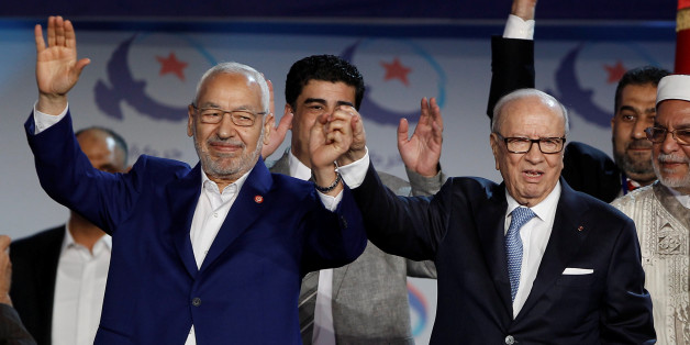 Tunisian President Beji Caid Essebsi (R) and Rached Ghannouchi, leader of the Islamist Ennahda movement, gesture during a congress of the Ennahda movement in Tunis,Tunisia May 20, 2016. Zoubeir Souissi