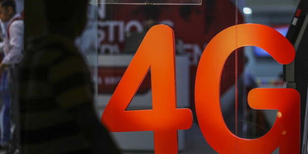 A pedestrian walks past a 4G sign displayed at a Bharti Airtel Ltd. store in Mumbai, India, on Monday, Oct. 24, 2016. Bharti Airtel is scheduled to release second-quarter earnings figures on Oct. 25. Photographer: Dhiraj Singh/Bloomberg via Getty Images