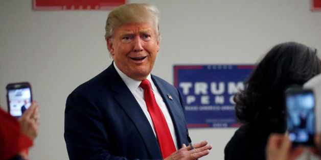 Republican presidential nominee Donald Trump walks into a phone bank before a campaign rally in Greeley, Colorado, U.S. October 30, 2016. REUTERS/Carlo Allegri