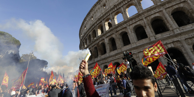 People march through downtown Rome to protest Matteo Renzi's government politics, Saturday, Oct. 22, 2016. In background is the Colosseum. ( AP Photo/Andrew Medichini)